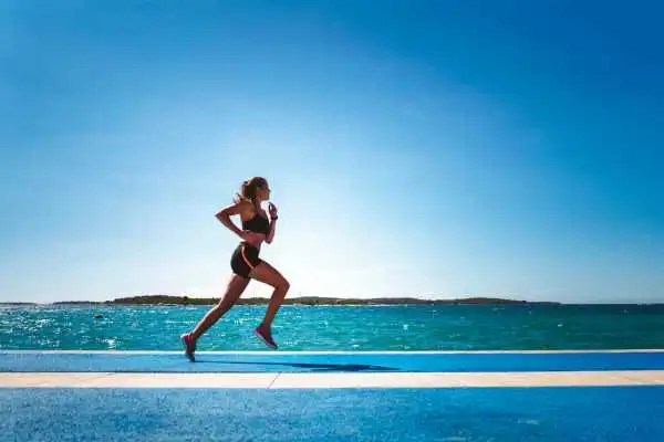 Woman running showing strong leg muscle Sherborne